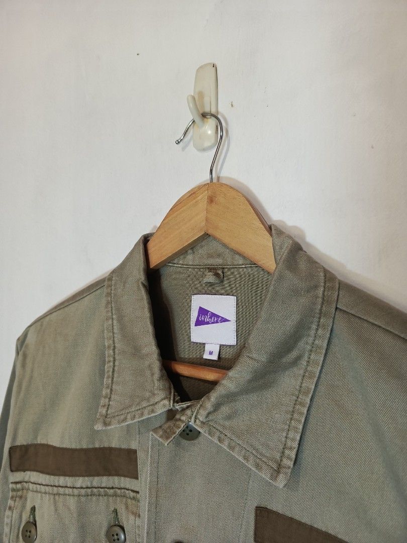 INHERE OLIVE GREEN UTILITY JACKET (Category: Coats, Jackets and Outerwear) located in Baguio. Submitted by 074thriftmania (Listing ID 1466167636, Image 3). Description: - Brand: Inhere - Size: M - Color: Olive green with dark brown contrast panels - Closure: Button-up front - Pockets: Multiple front flap pockets and sleeve pocket with button closure - Details: Structured collar, buttoned cuffs, solid plain back - Style: Great layering piece for c