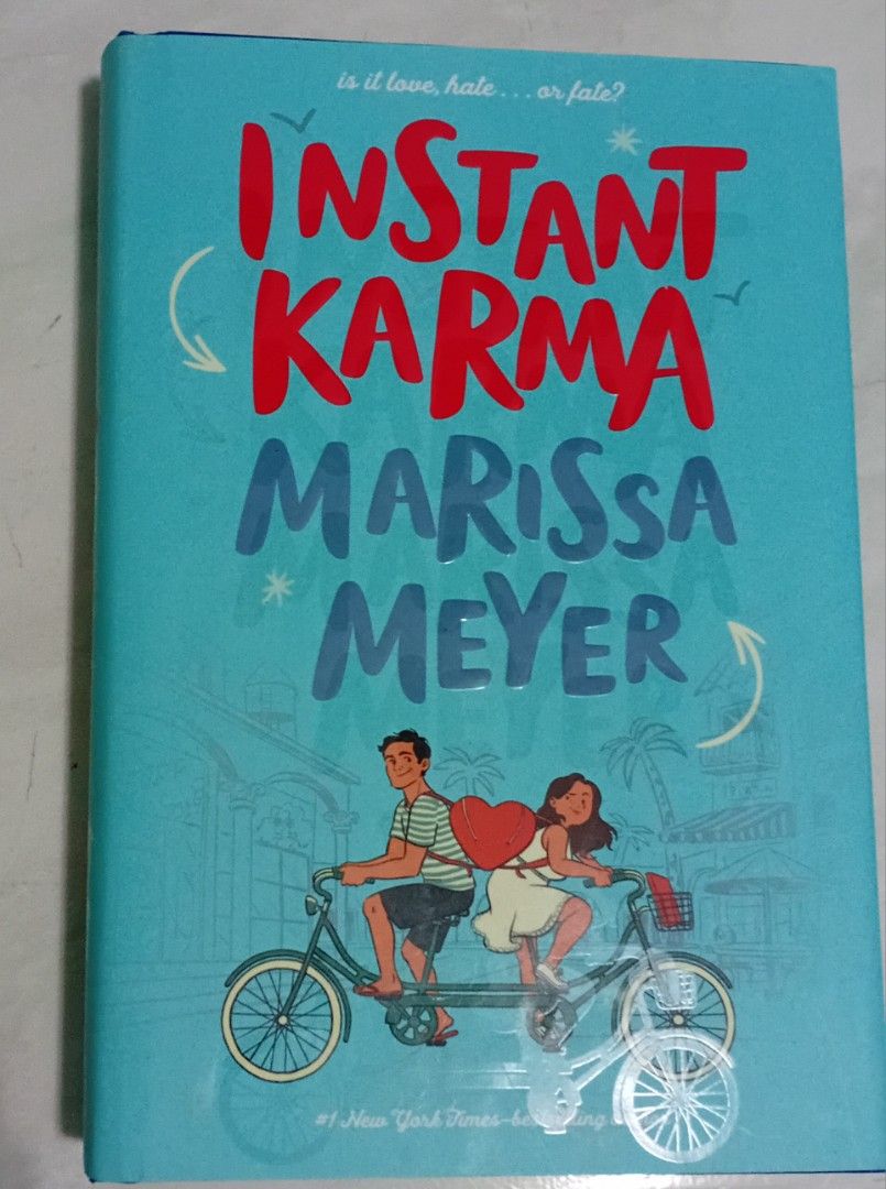 Instant Karma by Marissa Meyer (Category: Storybooks) located in Manila. Submitted by luckyfox-3a3e (Listing ID 1466310105, Image 1). Description: - Title: YA Contemporary Romance Novel by Marissa Meyer - Format: Hardcover edition with a bright blue tandem bicycle cover - ISBN: 9781250618818 - Condition: Clean pages, solid spine, good reading copy - Retail Price: P 499.00.