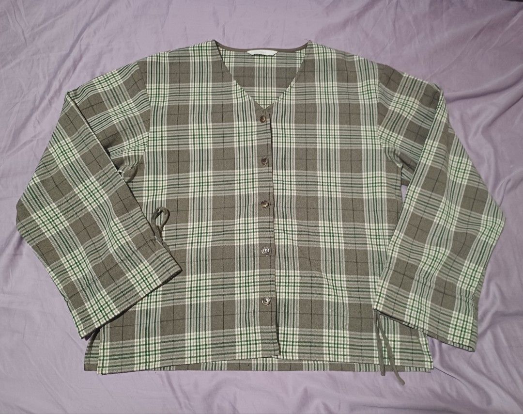 Intique Green Brown Plaid Button Up Blouse Top (Category: Blouses) located in San Juan City. Submitted by marie_d_r (Listing ID 1466251634, Image 2). Description: - Brand: Intique - Pattern: Green and brown plaid - Neckline: V-neck with front brown buttons - Sleeves: Long sleeves with adjustable tie-string cuffs - Fit: Lightweight and comfortable fabric - Condition: Excellent pre-loved condition (ready to wear!).