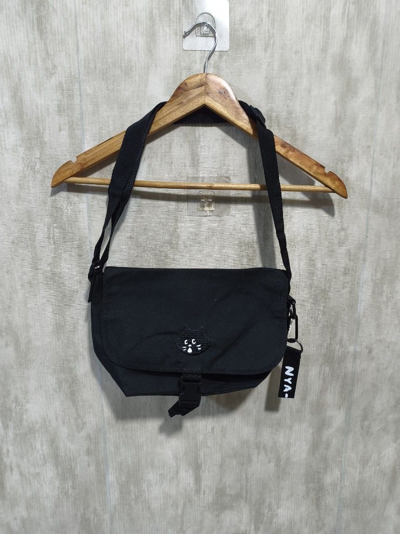 ISSEY MIYAKE NE-NET SLING BAG (Category: Cross-body Bags) located in Santiago. Submitted by dc_daily_thrift (Listing ID 1466310093, Image 1). Description: - ISSEY MIYAKE NE-NET SLING BAG - Color: Classic Black - Material: Durable and clean canvas - Features: Cute embroidered cat face patch and front buckle closure - Strap: Adjustable for comfortable wear - Storage: Handy back slip pocket and main compartment fits phone, wallet, and essentials - E