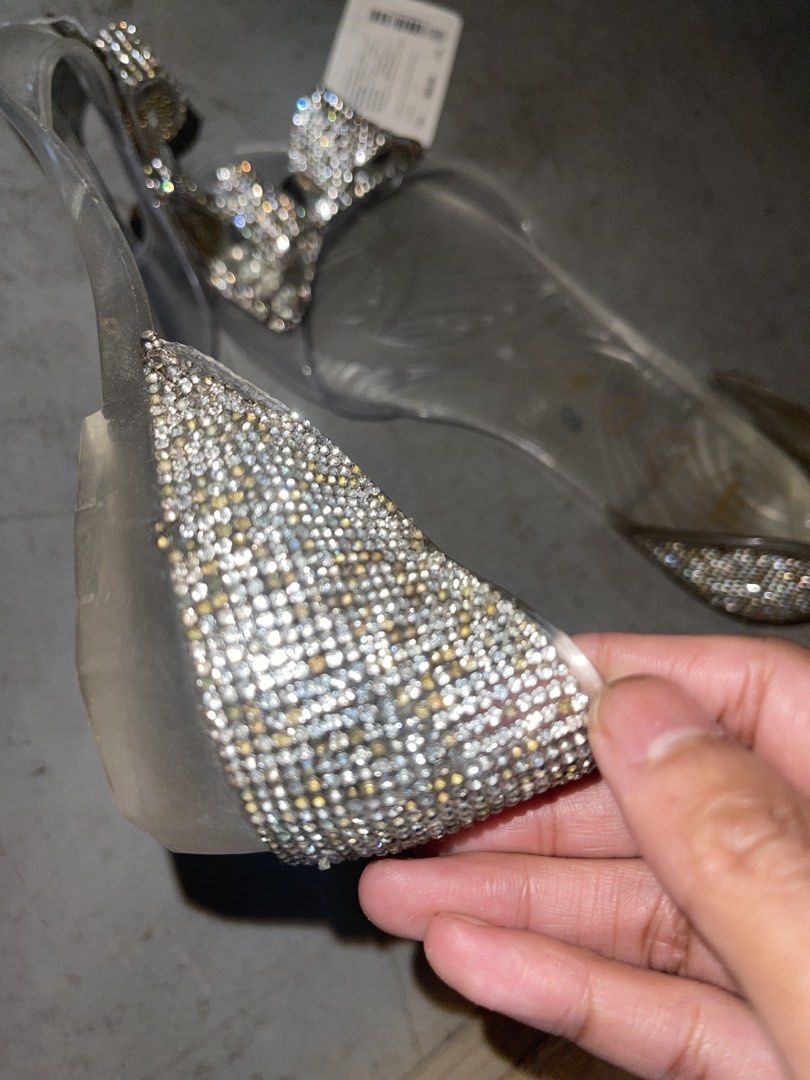 Jelly Bunny Clear Rhinestone Bow Flat Sandals (Category: Flats & Sandals) located in La Trinidad. Submitted by potatothriftlip (Listing ID 1466238981, Image 3). Description: Clear jelly sandals from Jelly Bunny. Rhinestone encrusted bow on the front strap. Heel area fully covered in tiny sparkling crystals. Slip-on design with transparent sole and heart graphics printed inside. Size 38 marked on the insole. Original store tag attached with price 