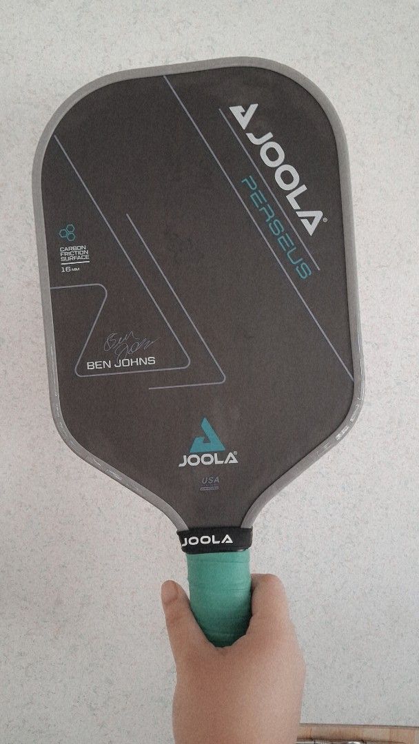 Joola Ben Johns Persues Pickleball Paddle & Balls (Category: Racket and Ball Sports) located in Manila. Submitted by katrinani48337 (Listing ID 1466156453, Image 1). Description: - Brand: Joola Ben Johns Perseus 16mm Pickleball Paddle - Surface: Carbon friction surface for ultimate spin and control - Grip: Fresh turquoise overgrip freshly wrapped - Feature: Official printed signature of Ben Johns - Bonus: 1 unopened tube of 3 Franklin X-40 outdoo