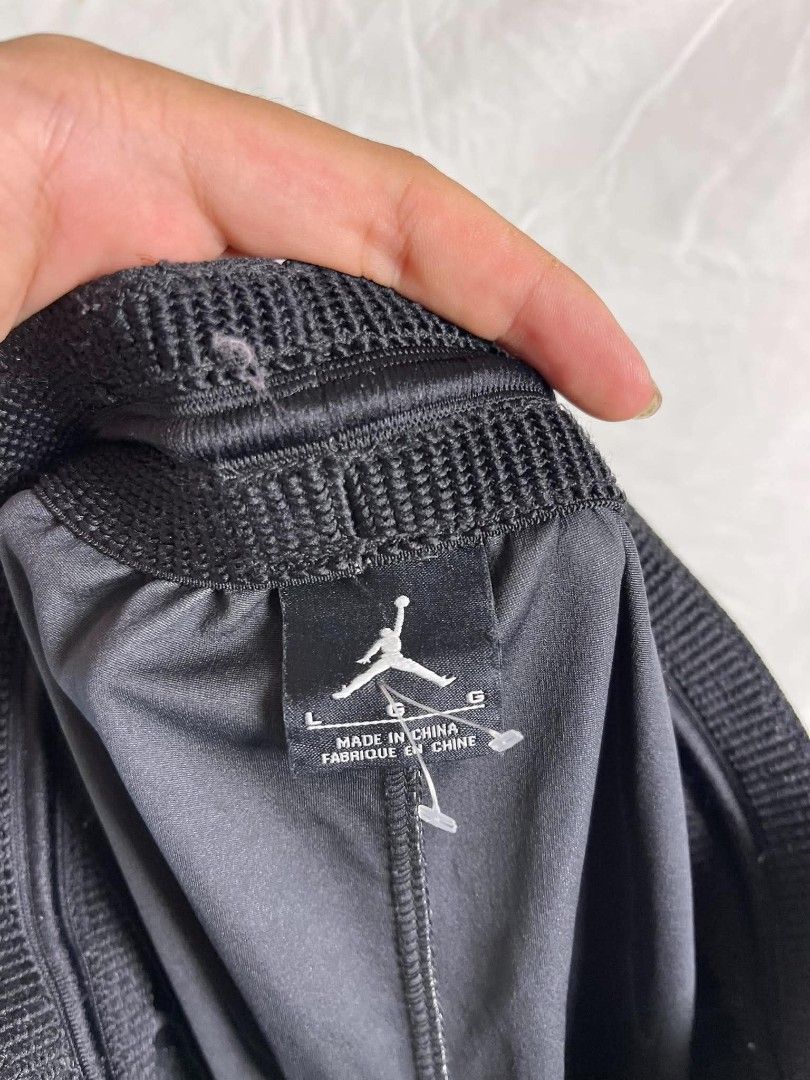 Jordan Black Track Pants Size L (Category: Joggers) located in Manila. Submitted by japee55 (Listing ID 1466321535, Image 2). Description: - Brand: Jordan - Color: Black - Size: Large - Material: 100% polyester - Waistband: Elastic with Jumpman logo near the left pocket - Cuffs: Ribbed at the bottom ankles - Condition: Brand new with tags attached showing care and sizing info.