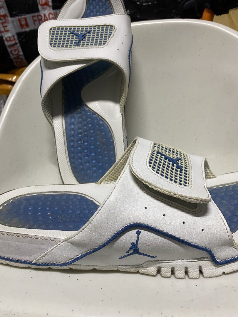 Jordan Hydro slides white blue size 11 (Category: Slippers & Slides) located in Pasacao. Submitted by wengpullar37205 (Listing ID 1466329618, Image 2). Description: - Brand: Jordan Slides - Color: White and blue with iconic Flight and Jumpman logos - Size: US 11 / UK 10 / EUR 45 - Features: Adjustable strap and blue cushioned footbed with circle pattern - Condition: Pre-loved with normal wear - Flaws: Dirt marks on blue insoles, slight yellowing 