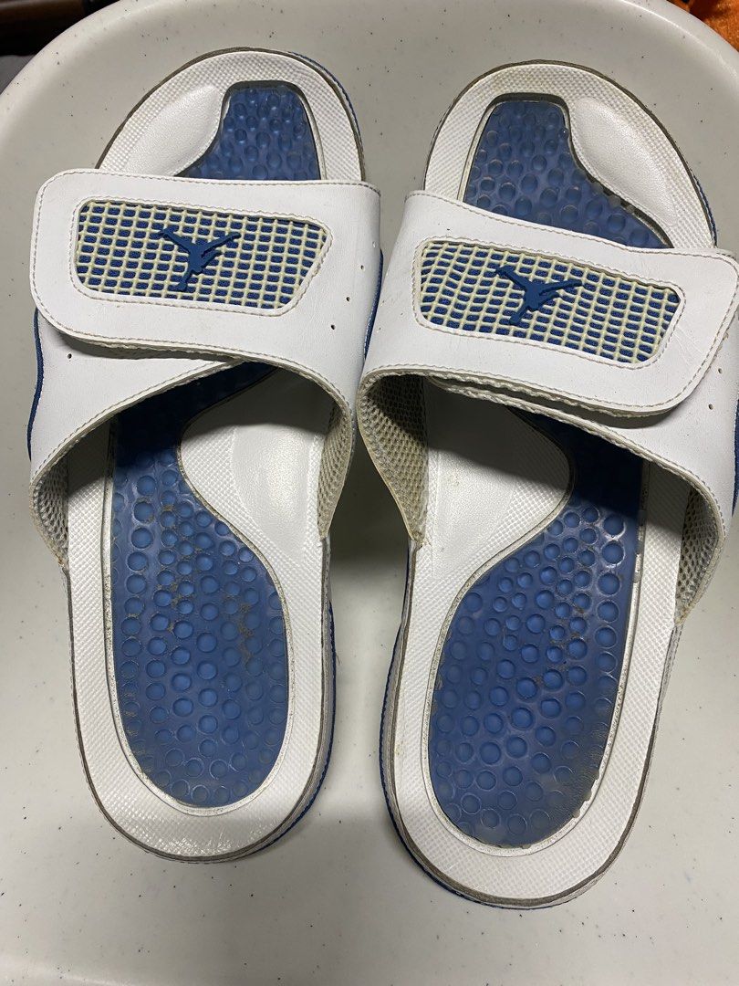 Jordan Hydro slides white blue size 11 (Category: Slippers & Slides) located in Pasacao. Submitted by wengpullar37205 (Listing ID 1466329618, Image 1). Description: - Brand: Jordan Slides - Color: White and blue with iconic Flight and Jumpman logos - Size: US 11 / UK 10 / EUR 45 - Features: Adjustable strap and blue cushioned footbed with circle pattern - Condition: Pre-loved with normal wear - Flaws: Dirt marks on blue insoles, slight yellowing 