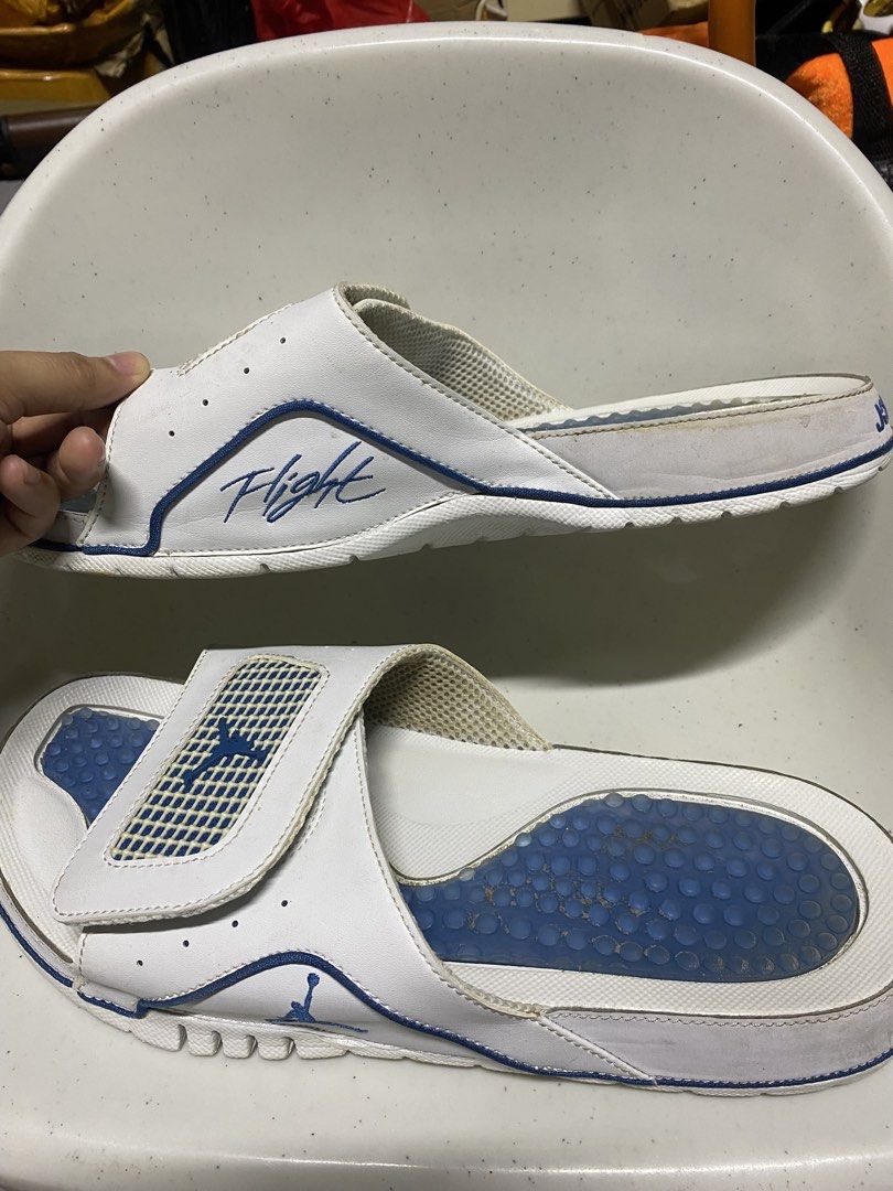 Jordan Hydro slides white blue size 11 (Category: Slippers & Slides) located in Pasacao. Submitted by wengpullar37205 (Listing ID 1466329618, Image 3). Description: - Brand: Jordan Slides - Color: White and blue with iconic Flight and Jumpman logos - Size: US 11 / UK 10 / EUR 45 - Features: Adjustable strap and blue cushioned footbed with circle pattern - Condition: Pre-loved with normal wear - Flaws: Dirt marks on blue insoles, slight yellowing 