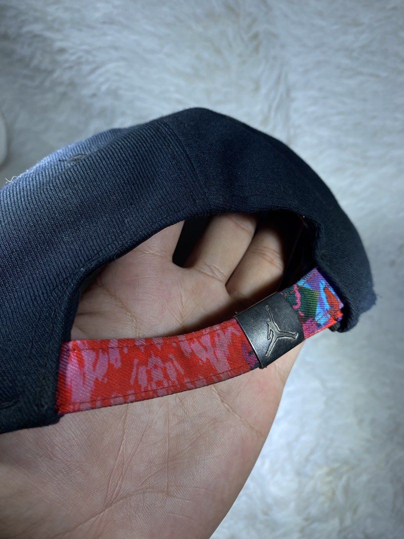 Jordan Jumpman Black Cap with Floral Undervisor (Category: Caps & Hats) located in Manila. Submitted by arthurmtb25357 (Listing ID 1466221405, Image 2). Description: - Brand: Jordan - Color: Black - Condition: Clean, great pre-loved condition - Design: Embroidered Jumpman logo on the front with a vibrant floral print under the brim and on the strapback - Details: Branded metal clasp closure and Jumpman text printed on the inside taped seams - Fit