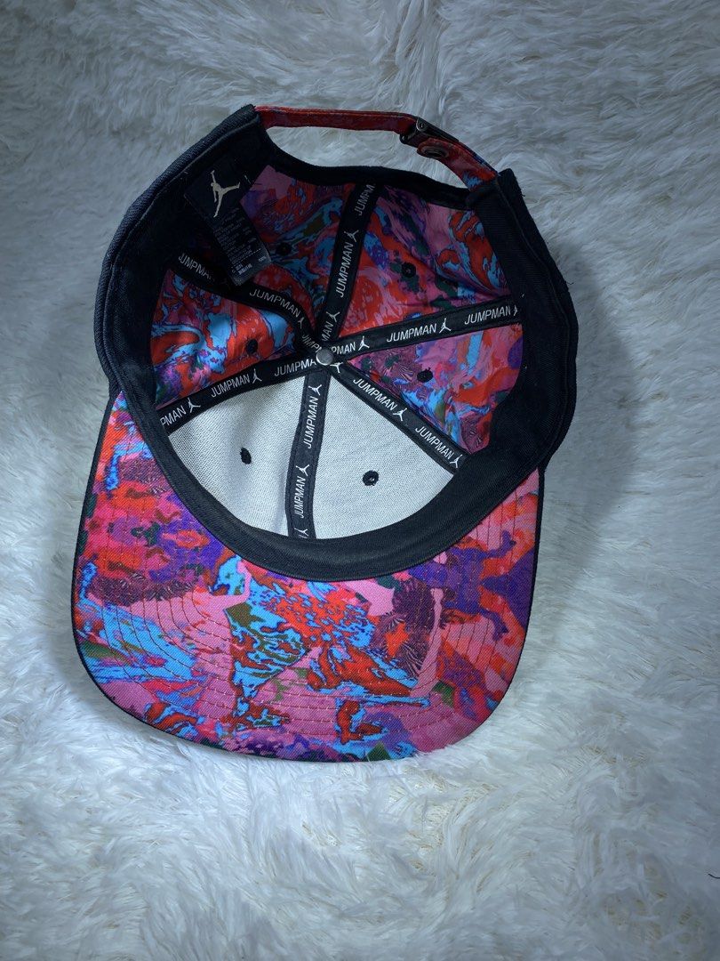 Jordan Jumpman Black Cap with Floral Undervisor (Category: Caps & Hats) located in Manila. Submitted by arthurmtb25357 (Listing ID 1466221405, Image 3). Description: - Brand: Jordan - Color: Black - Condition: Clean, great pre-loved condition - Design: Embroidered Jumpman logo on the front with a vibrant floral print under the brim and on the strapback - Details: Branded metal clasp closure and Jumpman text printed on the inside taped seams - Fit