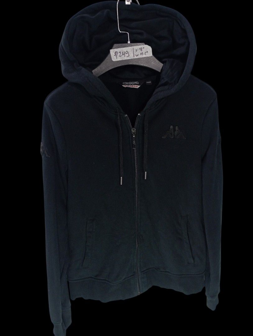 Kappa Black Full Zip Hoodie (Category: Coats, Jackets and Outerwear) located in Rodriguez. Submitted by enzo.tv (Listing ID 1466324491, Image 2). Description: Kappa full zip hoodie in black. Classic tonal embroidered logo on the chest and sleeve. Front pockets and drawstring hood. Tagged size extra large, but check actual measurements: length 18 inches, width 14.5 inches. Casual daily wear staple..