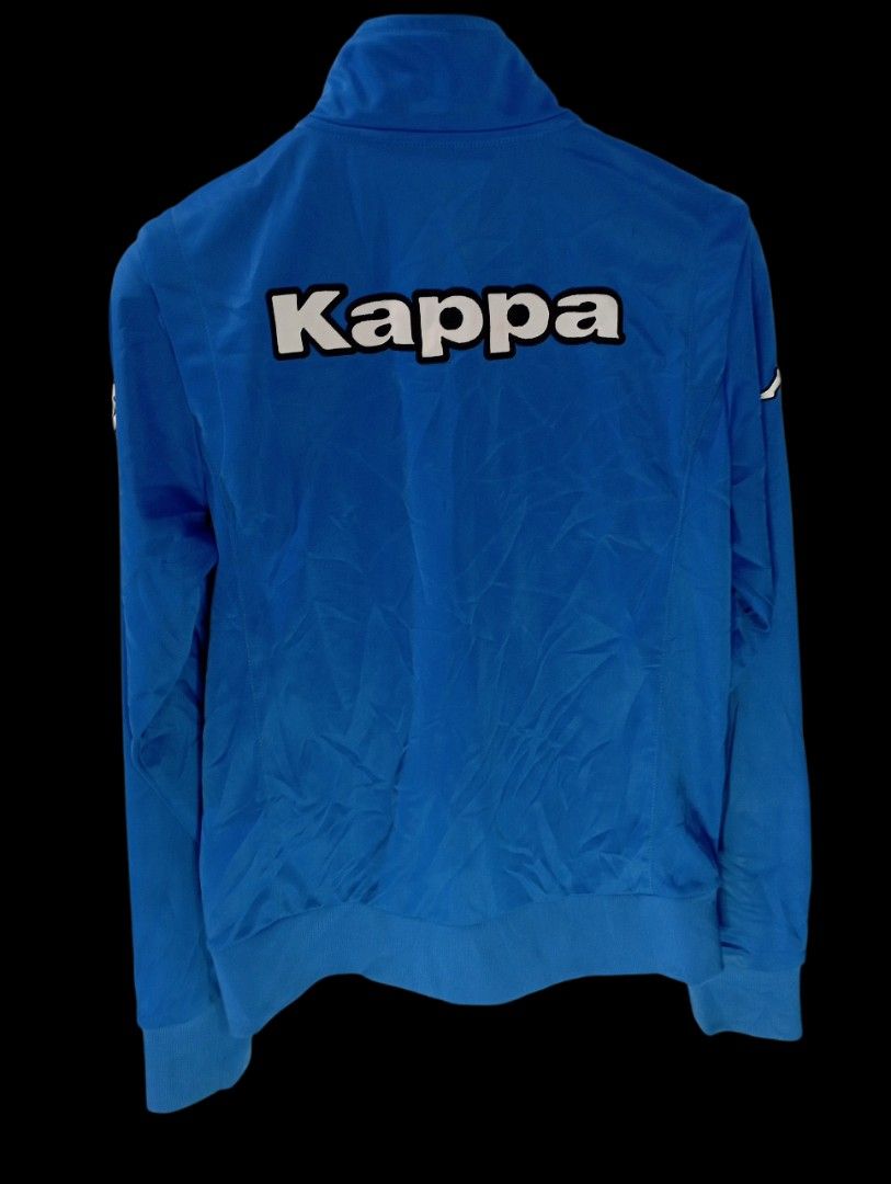 Kappa Blue Track Jacket (Category: Coats, Jackets and Outerwear) located in Rodriguez. Submitted by enzo.tv (Listing ID 1466324753, Image 3). Description: - Brand: Kappa - Color: Bright blue - Size: Small (Length: 17", Width: 13.5") - Design: Classic logo on right chest, Omini logo on left, large Kappa lettering on back - Features: High collar, full zip closure, ribbed cuffs and hem, practical zipped side pockets - Condition: Excellent.