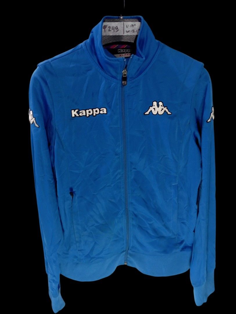 Kappa Blue Track Jacket (Category: Coats, Jackets and Outerwear) located in Rodriguez. Submitted by enzo.tv (Listing ID 1466324753, Image 2). Description: - Brand: Kappa - Color: Bright blue - Size: Small (Length: 17", Width: 13.5") - Design: Classic logo on right chest, Omini logo on left, large Kappa lettering on back - Features: High collar, full zip closure, ribbed cuffs and hem, practical zipped side pockets - Condition: Excellent.