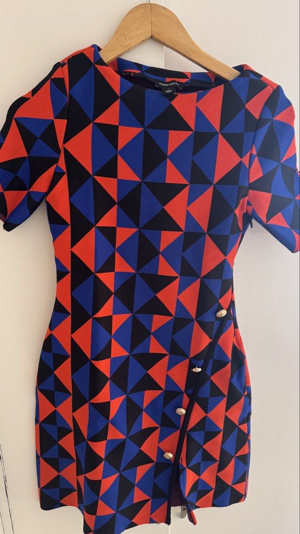 Karen Millen Geometric Pattern Dress Size S (Category: Dresses) located in Quezon City. Submitted by meezck (Listing ID 1466185554, Image 1). Description: - Brand: Karen Millen - Size: S - Colorway: Bold red, blue, and black geometric color-block pattern - Design: Short sleeves, round neckline, fitted silhouette, and wrap-style front - Details: Eye-catching gold lion-embossed decorative buttons - Closure: Convenient zipper fastening along the sid