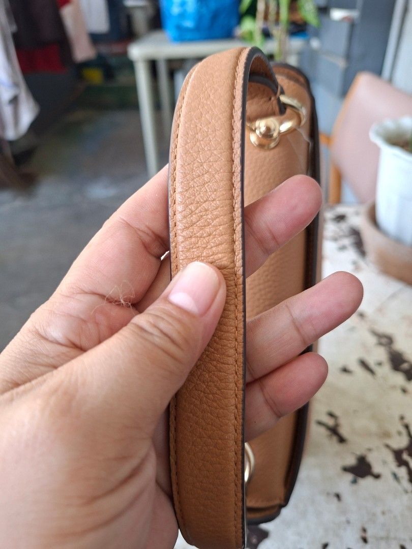 Kate Spade Kyla Pebbled Leather Top Handle Bag (Category: Tote Bags) located in Imus. Submitted by graceannes06899 (Listing ID 1466194908, Image 3). Description: - Brand: Kate Spade - Style: Kyla Top Handle Bag - Color: Classic Camel - Material: Premium pebble leather - Hardware: Gold-tone with logo lettering - Closure: Secure zip top with fabric lining - Extras: Includes structured top handle and adjustable strap - Condition: Brand new with orig