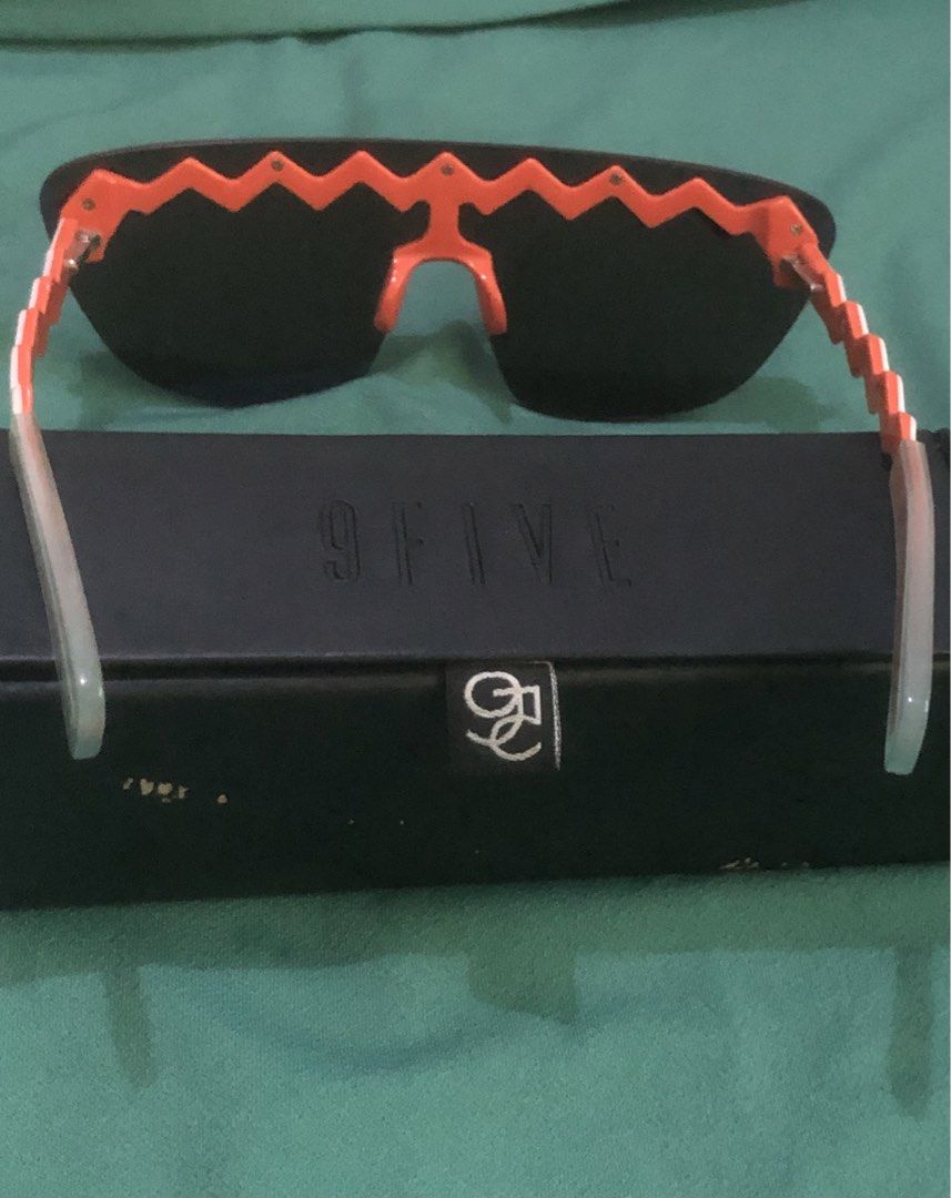 Kenzo x H&M Zigzag Sunglasses with Case (Category: Sunglasses & Eyewear) located in Quezon City. Submitted by unique2shop (Listing ID 1466177658, Image 3). Description: - Authentic Kenzo x H&M designer collaboration sunglasses - Bold orange and white zigzag frame design with dark tinted lenses - Includes a sleek black 9FIVE branded storage box - Standout streetwear accessory perfect for making a statement - Condition: Excellent / brand new never 