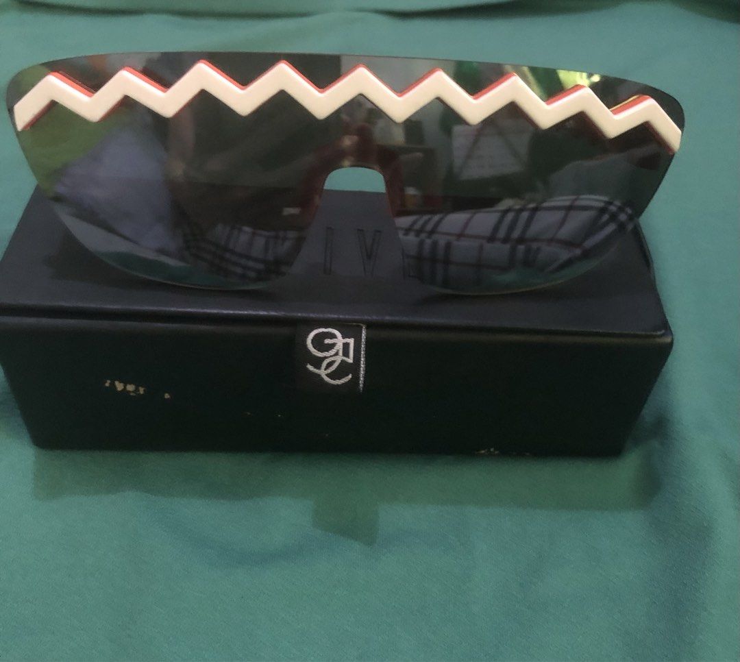 Kenzo x H&M Zigzag Sunglasses with Case (Category: Sunglasses & Eyewear) located in Quezon City. Submitted by unique2shop (Listing ID 1466177658, Image 1). Description: - Authentic Kenzo x H&M designer collaboration sunglasses - Bold orange and white zigzag frame design with dark tinted lenses - Includes a sleek black 9FIVE branded storage box - Standout streetwear accessory perfect for making a statement - Condition: Excellent / brand new never 