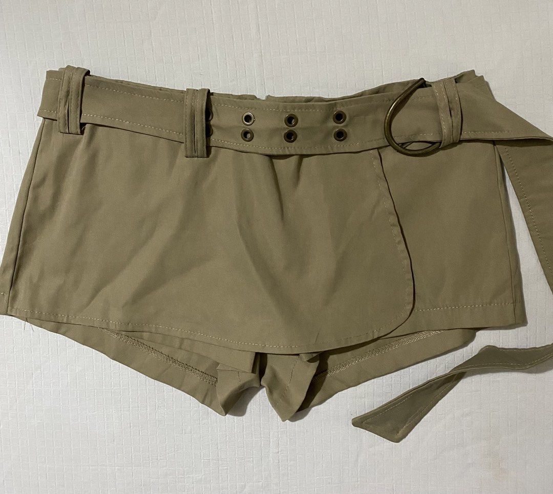 Khaki Belted Skort With D-Ring Buckle (Category: Skirts) located in Quezon City. Submitted by getitrightaway.ph (Listing ID 1466261624, Image 2). Description: - Color: Khaki - Design: High-waist skorts with attached wrap skirt panel - Security: Built-in shorts underneath (no wardrobe malfunction worries!) - Details: Includes matching belt with metal eyelets and D-ring buckle - Material: Smooth, super comfortable fabric - Styling: Easy to match wi