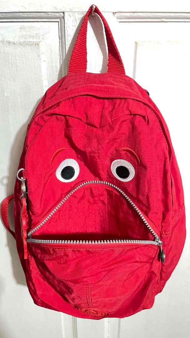 Kipling Red Monster Googly Eyes Backpack (Category: Backpacks) located in Manila. Submitted by xtinamendo00659 (Listing ID 1466287442, Image 2). Description: - Brand: Kipling mini backpack - Color: Bright red - Design: Quirky monster eyes and mouth zippered pocket - Material: Clean crinkle nylon fabric - Inclusion: Signature matching red monkey keychain charm - Hardware & Straps: Adjustable shoulder straps with black plastic hardware - Condition:
