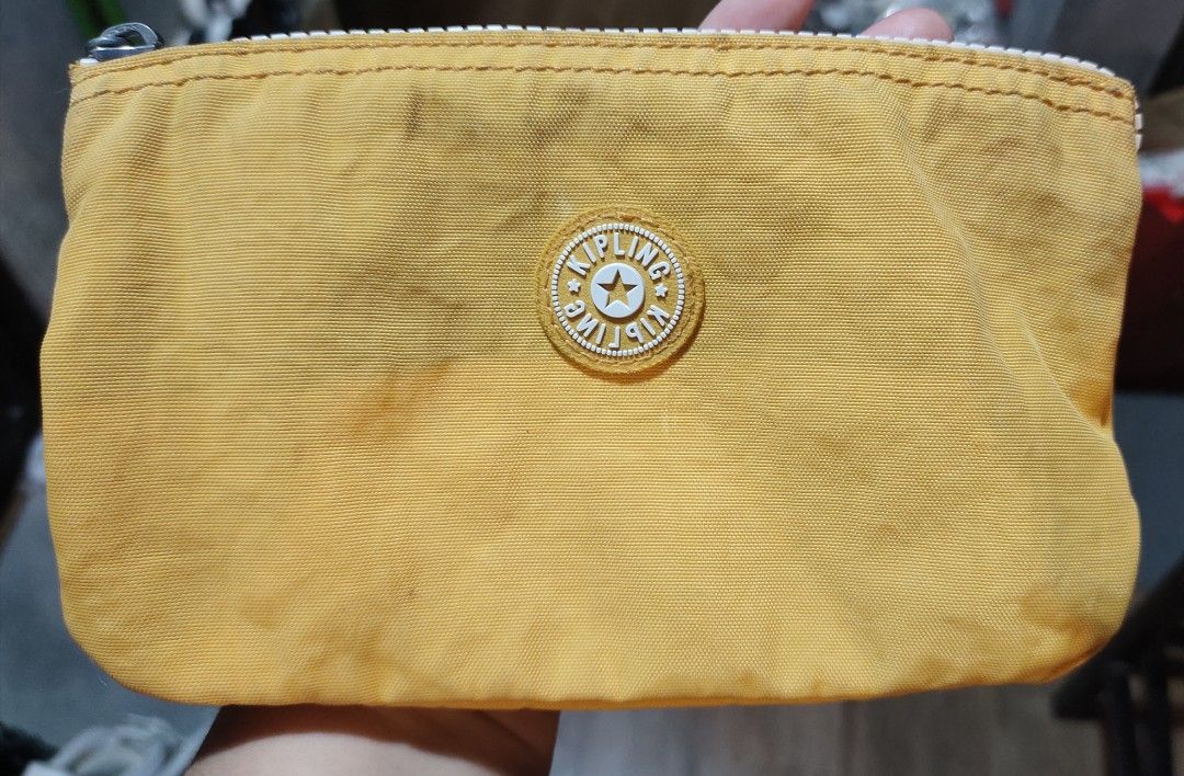 Kipling Yellow Pouch with Monkey Keychain (Category: Purses & Pouches) located in Calamba. Submitted by callcay (Listing ID 1466243441, Image 2). Description: - Authentic Kipling zipper pouch in a cheerful bright yellow shade - Made of durable and signature crinkled nylon material -with minimal flaw and ink stain - Features the iconic round Kipling logo patch on the front - Comes with an adorable matching yellow rubber monkey keychain - Secure to