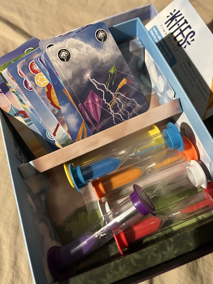 Kites Board Game (Category: Board Games & Puzzles) located in Pagsanjan. Submitted by kaffeen (Listing ID 1466294933, Image 2). Description: ‼️FOR SALE: Kites‼️ ➡️ 1100 + SF ➡️ In Kites, everyone works together to keep all their kites — represented by colorful sand timers — in the air. Take turns playing cards, flipping the sand timers, and coordinating with other players to ensure none of the timers run out. If it does, a kite has crashed! Add c