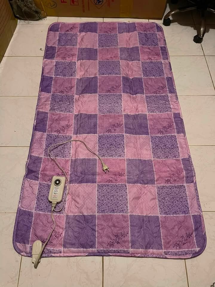 Korean Electric Heating Mat with Auto Controller (Category: Home Improvement Tools & Accessories) located in Baguio. Submitted by ljen2574460 (Listing ID 1466336760, Image 1). Description: Purple checkered electric mat, made in Korea. Runs on 220V with 140W power consumption. Includes original auto temperature controller attached. Folds up easily for storage when not in use. Keeps you warm during cold nights. Clean condition overall, works well..