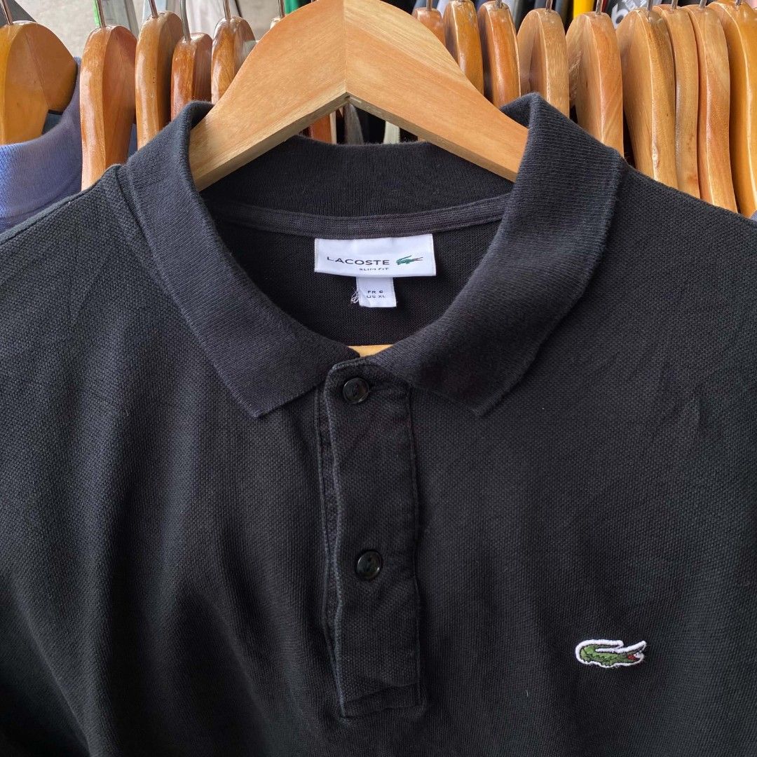 Lacoste Black Polo Shirt (Category: Tshirts & Polo Shirts ) located in Lupon. Submitted by kent_thrift (Listing ID 1466203300, Image 2). Description: -Dimes: 21x26 -Size:XL on tag -Issue Nickline -1200Ship - Authentic Black Lacoste Polo Shirt - Classic button placket and collar - Iconic embroidered crocodile logo on left chest - Standard fit with short sleeves - Ribbed collar and sleeve cuffs - Versatile, pairs easily with jeans or shorts - Condi