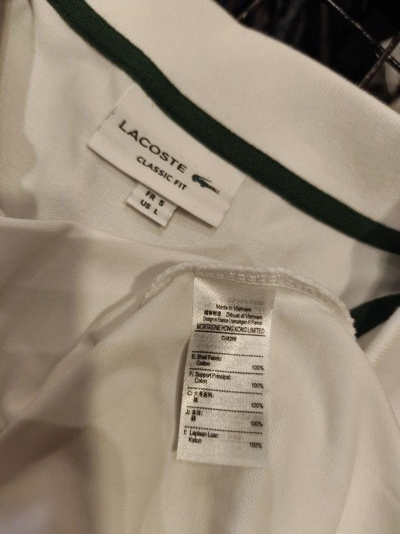 Lacoste Classic White Polo Shirt (Category: Tshirts & Polo Shirts ) located in Davao. Submitted by _jetnest25 (Listing ID 1466217648, Image 2). Description: - Brand: Lacoste - Color: Clean solid white with green inner neckline trim - Style: Short sleeve polo shirt with classic collar and two-button placket - Detailing: Iconic green embroidered crocodile logo on the left chest, ribbed cuffs and hem - Versatility: Perfect staple piece for casual an