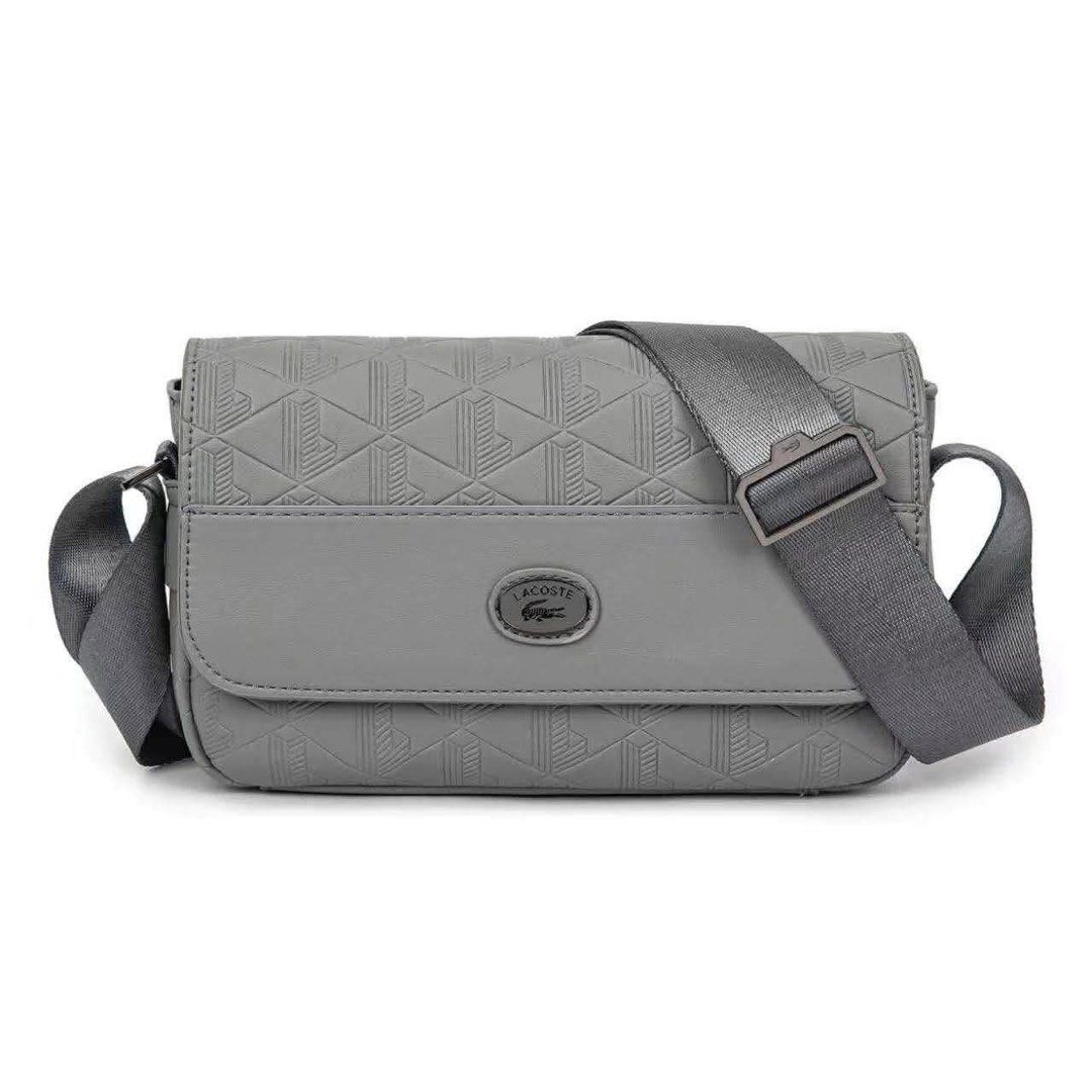Lacoste Monogram Leather Flap Close Satchel (Category: Sling Bags) located in Quezon City. Submitted by stuffs.hellyy (Listing ID 1466319633, Image 2). Description: • Design: Features a smooth leather accent panel, a tonal enameled Lacoste logo badge, and an adjustable textile shoulder strap. • Storage: Offers a main compartment with an internal zip pocket, a rear exterior pocket, and a magnetic flap closure..