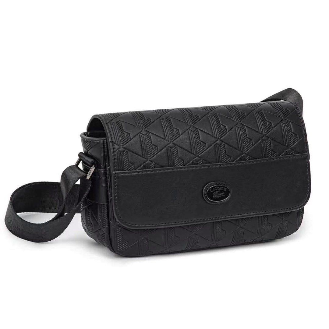Lacoste Monogram Leather Flap Close Satchel (Category: Sling Bags) located in Quezon City. Submitted by stuffs.hellyy (Listing ID 1466319633, Image 1). Description: • Design: Features a smooth leather accent panel, a tonal enameled Lacoste logo badge, and an adjustable textile shoulder strap. • Storage: Offers a main compartment with an internal zip pocket, a rear exterior pocket, and a magnetic flap closure..