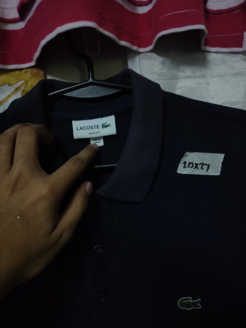 Lacoste Navy Blue Polo Shirt (Category: Tshirts & Polo Shirts ) located in Manila. Submitted by montillano25396 (Listing ID 1466281447, Image 2). Description: Lacoste Navy Blue Polo Shirt Size: Large Good Condition issue: fadings on collar.
