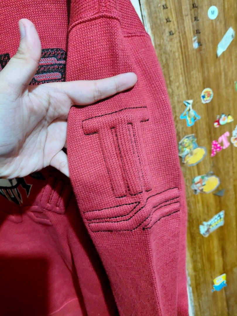 Lancel Paris Red Knit Sweater with Jeans Patch (Category: Coats, Jackets and Outerwear) located in Imus. Submitted by frootiloots4103 (Listing ID 1466314430, Image 3). Description: - Brand: Lancel Paris - Size: Large - Color: Red - Design: Bold 'Jeans' embroidery with a central patch graphic - Details: Textured ribbed stitching on sleeves and gold brand label inside the collar - Style: Long sleeves, crew neck knit sweater - Condition: Excellent O
