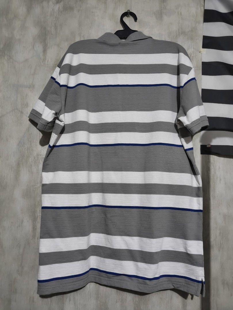 Lee Striped Polo Shirt Grey White Blue (Category: Tshirts & Polo Shirts ) located in Baguio. Submitted by fordaluvofthrift2600 (Listing ID 1466169049, Image 2). Description: - Brand: Lee - Condition: Brand new with tags (BNWT) - Design: Grey, white, and thin blue stripes with textured fabric - Details: Classic button-up collar, short sleeves, embroidered chest logo, and small logo patch near the hem - Style: Versatile smart-casual polo shirt FIT 