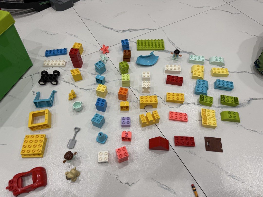 LEGO DUPLO Extra Ideas Brick Box 10914 (85pcs) (Category: Lego & Building Sets) located in Manila. Submitted by paula021690 (Listing ID 1466158607, Image 3). Description: Inclusion: - Storage box - duplo 81pcs (missing 4pcs, see 4th pic for reference) - Freebies duplo LEGO DUPLO Extra Ideas set in green storage box with lid. Includes colorful bricks, vehicle bases, figures, flowers, and instruction booklet. Few pieces missing marked on manual, pl