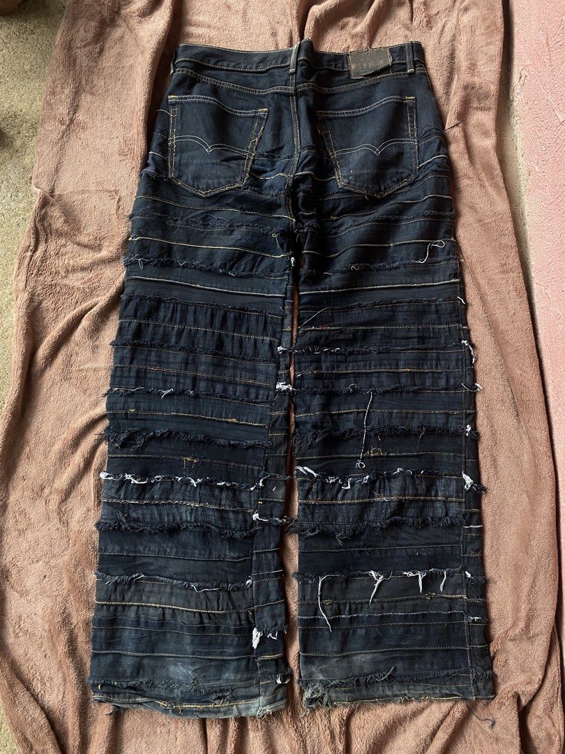 Levi's Custom Distressed Panelled Denim Pants Black (Category: Jeans) located in Carcar. Submitted by eroncarvaj68638 (Listing ID 1466215158, Image 2). Description: - Brand: Custom Levi's - Color: Black denim with contrast yellow stitching - Style: Heavily distressed with horizontal shredded panels down both legs - Unique Details: Front thigh belt loops and aged leather patch on the front pocket - Pockets: Classic five-pocket styling with standar