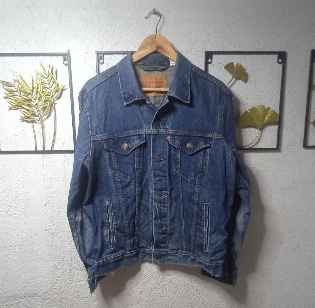 Levi's Denim Jacket Size M (Category: Coats, Jackets and Outerwear) located in Kawit. Submitted by deidzdzn (Listing ID 1466216974, Image 2). Description: - Brand: Levi's - Style: Classic denim jacket in dark blue wash - Size: M (Width: 21.5 inches, Length: 24 inches) - Features: Button-up front, chest pockets, and side welt pockets - Condition: Timeless piece, perfect for everyday wear.