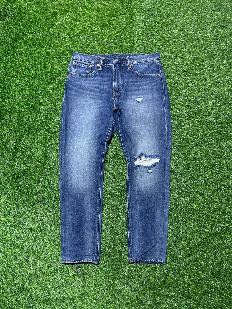 Levi's Distressed Denim Jeans (Category: Jeans) located in Pangantucan. Submitted by calmwhale_cb83a8 (Listing ID 1466263698, Image 2). Description: -levis 512 | w32 | L37 altered | H5.8 - Wash: Blue denim with factory fading and whiskering - Details: Ripped knee on the left leg with a small distress mark above - Design: Classic five-pocket setup with a zip fly and branded metal button - Branding: Leather patch on the back waistband - Fit: Straig