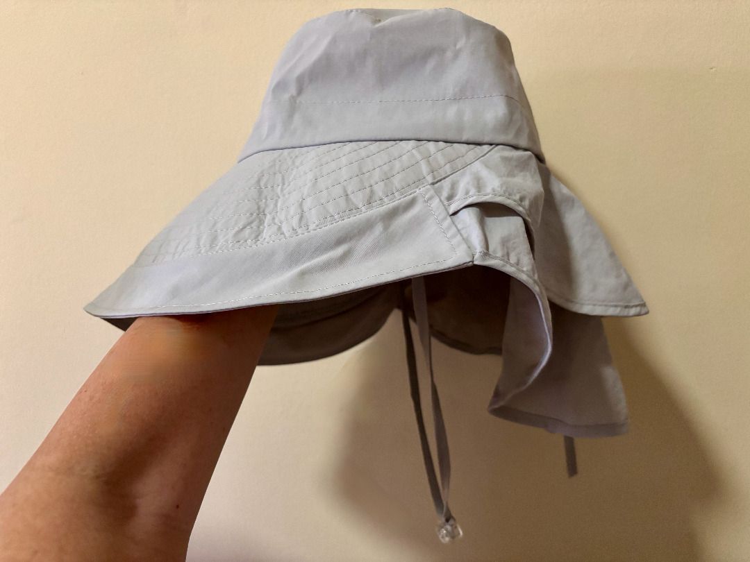 Light grey sun hat with neck flap and drawstring (Category: Hats & Beanies) located in Quezon City. Submitted by leahs.stuff (Listing ID 1466214816, Image 3). Description: - Color: Light Grey - Full coverage: Wide brim and attached neck flap - Secure fit: Adjustable chin straps with a toggle - Travel-friendly: Lightweight and easy to pack into any bag - Ideal for outdoor activities like gardening, hiking, and beach trips.