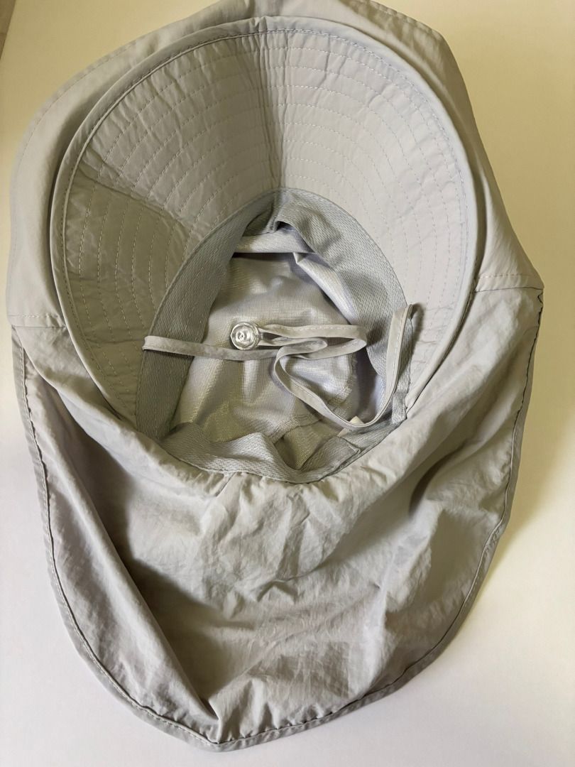 Light grey sun hat with neck flap and drawstring (Category: Hats & Beanies) located in Quezon City. Submitted by leahs.stuff (Listing ID 1466214816, Image 2). Description: - Color: Light Grey - Full coverage: Wide brim and attached neck flap - Secure fit: Adjustable chin straps with a toggle - Travel-friendly: Lightweight and easy to pack into any bag - Ideal for outdoor activities like gardening, hiking, and beach trips.