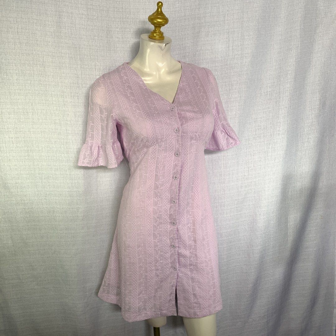 Lilac Button-Down V-Neck Dress with Ruffle Sleeves (Category: Dresses) located in Rizal. Submitted by shop_ms.lai (Listing ID 1464971486, Image 2). Description: - Color: Lilac - Style: V-neck mini dress with short ruffle sleeves - Details: Front button-down closure and textured fabric - Fit: Fitted bodice with an A-line skirt (hits above the knee) - Occasion: Perfect for casual days out and weekend brunches.