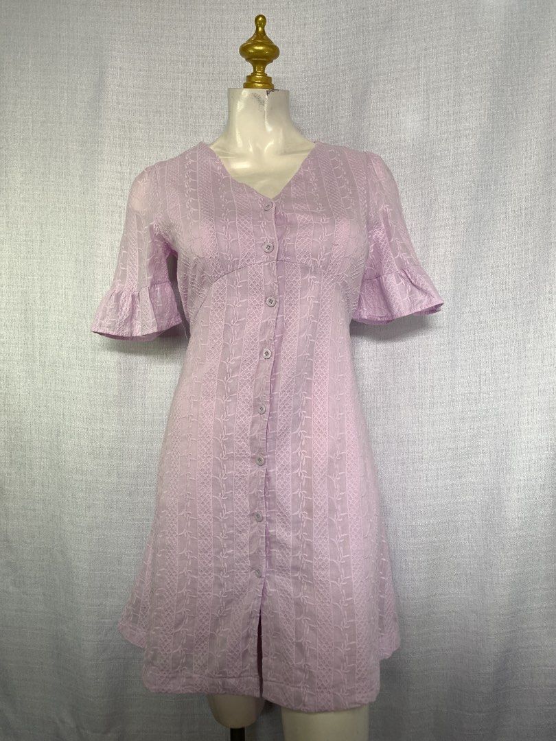 Lilac Button-Down V-Neck Dress with Ruffle Sleeves (Category: Dresses) located in Rizal. Submitted by shop_ms.lai (Listing ID 1464971486, Image 3). Description: - Color: Lilac - Style: V-neck mini dress with short ruffle sleeves - Details: Front button-down closure and textured fabric - Fit: Fitted bodice with an A-line skirt (hits above the knee) - Occasion: Perfect for casual days out and weekend brunches.