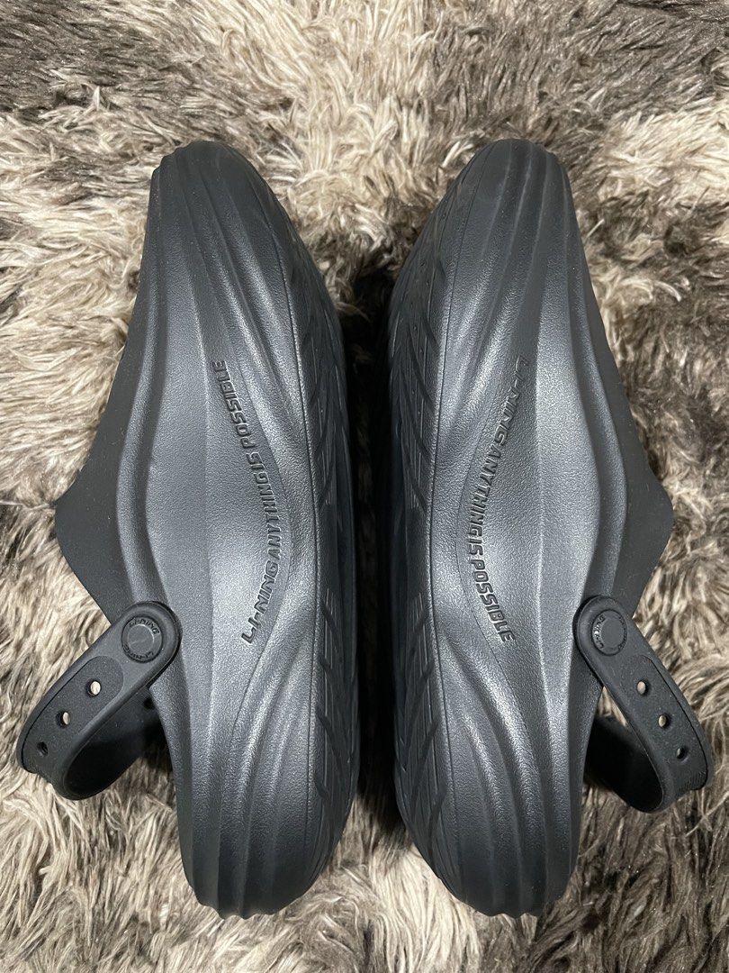 Li-Ning Black Slip-On Clogs Sandals (Category: Slippers & Slides) located in Calapan. Submitted by lucasthrifts (Listing ID 1466286205, Image 2). Description: - Brand: Li-Ning - Color: Black - Style: Slip-on clogs with 'Anything Is Possible' side text - Comfort & Breathability: Ventilation holes across the upper keep feet cool - Secure Fit: Adjustable back strap with button closure - Grip & Durability: Textured diamond pattern inside the sole and