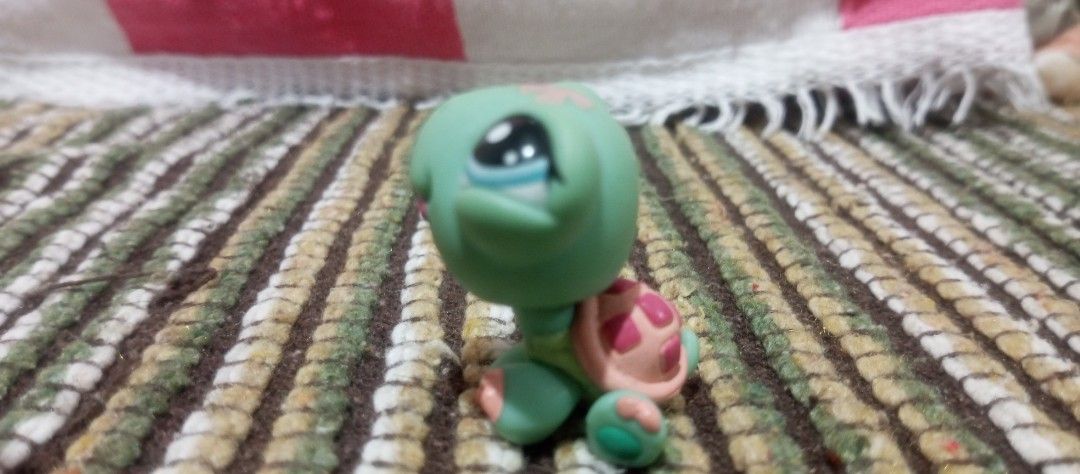Littlest Pet Shop Turtle Figure LPS (Category: Figurines & Statues) located in Victorias. Submitted by tobylacua26871 (Listing ID 1466274129, Image 3). Description: - Authentic Littlest Pet Shop (LPS) turtle figurine - Features cute blue eyes and a playful pink tongue - Peach-colored shell adorned with darker pink spots - Authentic markings: LPS stamped under back leg with copyright info on the bottom - Smoothly rotating head - Great addition to 