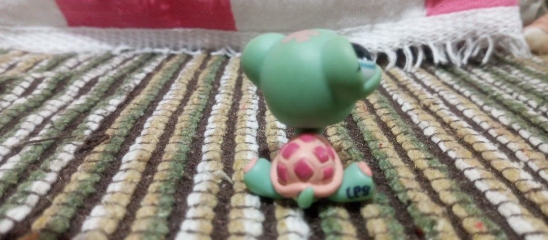 Littlest Pet Shop Turtle Figure LPS (Category: Figurines & Statues) located in Victorias. Submitted by tobylacua26871 (Listing ID 1466274129, Image 2). Description: - Authentic Littlest Pet Shop (LPS) turtle figurine - Features cute blue eyes and a playful pink tongue - Peach-colored shell adorned with darker pink spots - Authentic markings: LPS stamped under back leg with copyright info on the bottom - Smoothly rotating head - Great addition to 