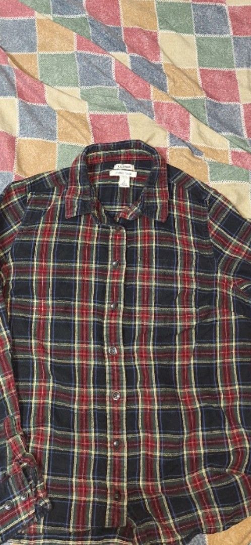 LL Bean plaid flannel shirt (Category: Tshirts & Polo Shirts ) located in Valenzuela. Submitted by janoski143 (Listing ID 1466181084, Image 1). Description: Classic plaid flannel shirt from L.L. Bean. Navy blue base with red, yellow, and green plaid pattern throughout. Long sleeves with button cuffs. Traditional button-down front with a standard collar. Soft flannel fabric, comfortable for cooler weather. Standard fit. Great layering piece. 1000 