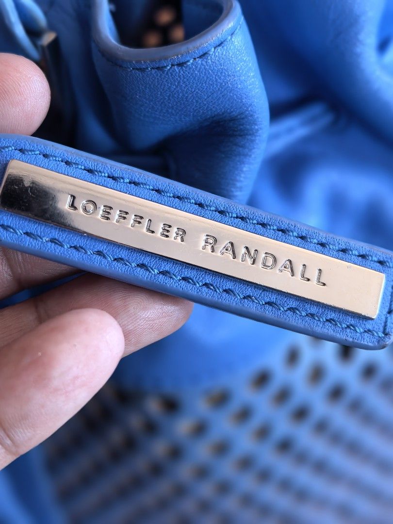 Loeffler Randall blue perforated leather bucket bag (Category: Cross-body Bags) located in Cagayan de Oro. Submitted by tommygurl1218 (Listing ID 1466220187, Image 2). Description: - Brand/Style: Loeffler Randall leather bucket bag in a bright blue shade - Design: Laser-cut perforation details on the lower half with a drawstring closure - Accents: Matching side tassel and silver-tone hardware rings on the shoulder strap - Condition: Base shows mi