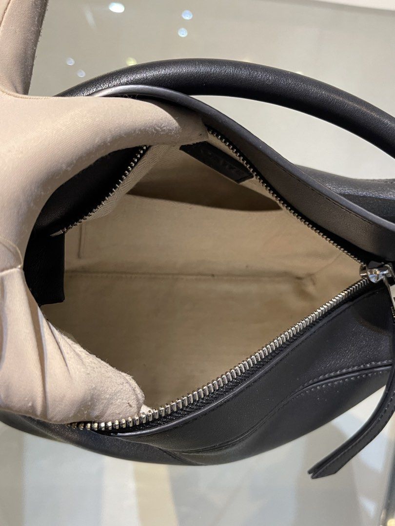Loewe Puzzle Edge Bag Black (Category: Luxury Bags & Wallets) located in Manila. Submitted by jmsluxe2026 (Listing ID 1466200847, Image 3). Description: Loewe Puzzle Edge bag in classic black leather. Distinctive geometric paneling, top handle, and detachable matching shoulder strap. Silver-tone hardware engraved with Loewe branding. Fabric lined interior with slip pocket. Includes embossed Loewe leather logo tag inside. Pristine black finish thr