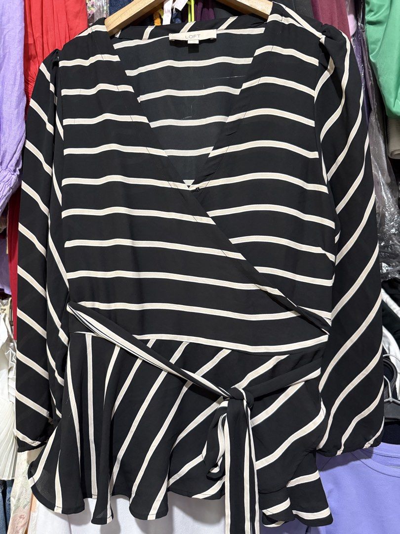 LOFT Black and White Striped Wrap Peplum Blouse (Category: Blouses) located in Antipolo. Submitted by harlowwillow (Listing ID 1466212593, Image 2). Description: NO TO LOW BALLERS Large on tag can fit up to XL W 20-22" L 27" - Brand: LOFT - Design: Black and white stripes with V-neck wrap front - Features: Matching tie belt at the waist, long sleeves with gathered shoulder details - Fabric: Lightweight and comfortable - Occasion: Versatile for wo