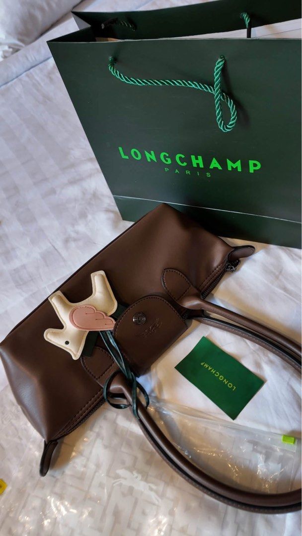 Long Champ (Category: Shoulder Bags) located in San Juan City. Submitted by kc.collection (Listing ID 1466275659, Image 1). Description: ₱999 +50 Paperbag +59 charm.