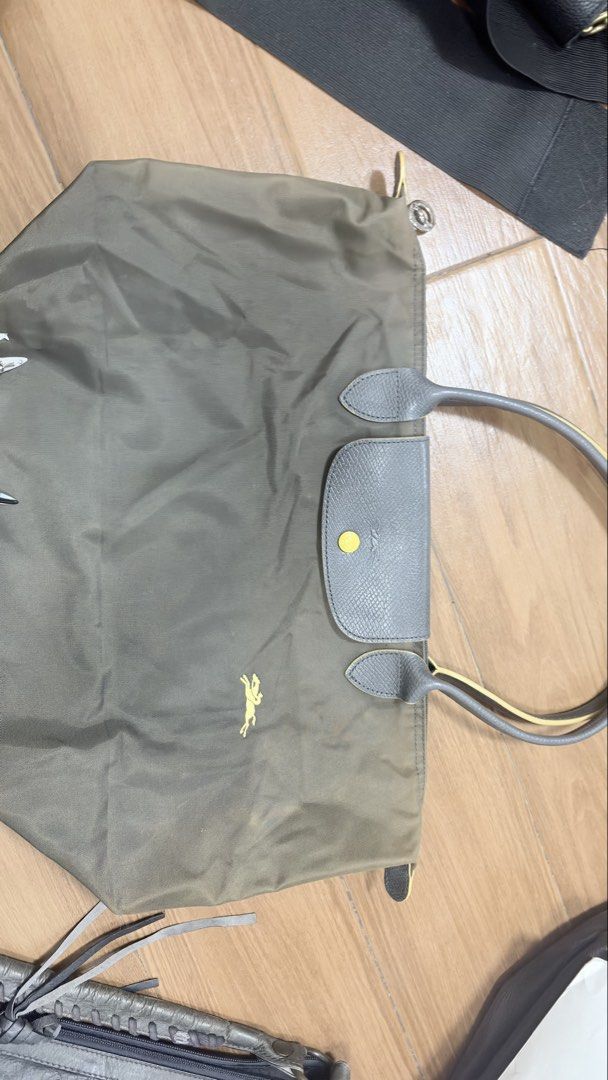 Longchamp Green Tote Bag (Category: Luxury Bags & Wallets) located in Manila. Submitted by serraphimav (Listing ID 1466292399, Image 1). Description: Green nylon tote bag from Longchamp. Grey leather handles and front flap closure with snap button. Yellow horse logo embroidered on the front. Double top handles. Spacious interior everyday bag..