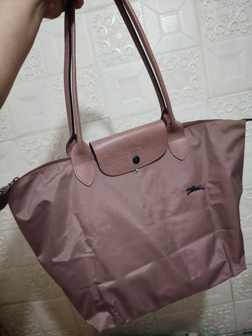 Longchamp Rose Pink Tote Bag (Category: Luxury Bags & Wallets) located in Pasig City. Submitted by purpleglitters (Listing ID 1466261784, Image 1). Description: - Color: Old Rose LLH - Style: Long-handled tote bag - Material: Durable nylon body with leather flap and snap closure - Hardware: Silver-toned top zipper - Interior: Spacious main compartment for daily essentials - Condition: Excellent / Well-maintained - Shipping: Nationwide via courier