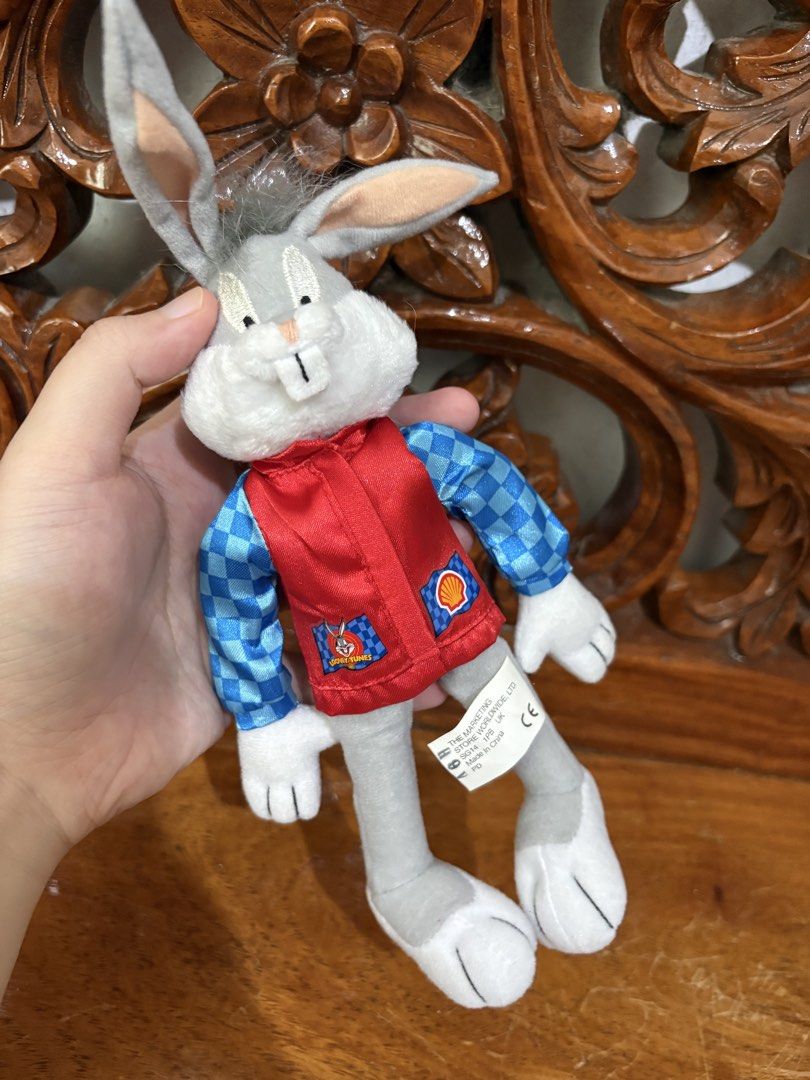 Looney Tunes Bugs Bunny Shell Racing Plush 1999 (Category: Plushies & Soft Toys) located in Quezon City. Submitted by rxyel (Listing ID 1466167622, Image 3). Description: - Vintage 1999 Warner Bros. Bugs Bunny plush toy - Wears a red vest over blue checkered sleeves - Features rare Shell oil branding and trophy graphic - Original tush tag attached with copyright details - Clean fabric, ideal for collectors and fans.